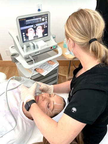 clinician-performing-ultherapy-victoria-treatment-on-female-patient-using-ultrasound-device-with-monitor-showing-facial-mapping-lines-during-non-surgical-skin-tightening-procedure